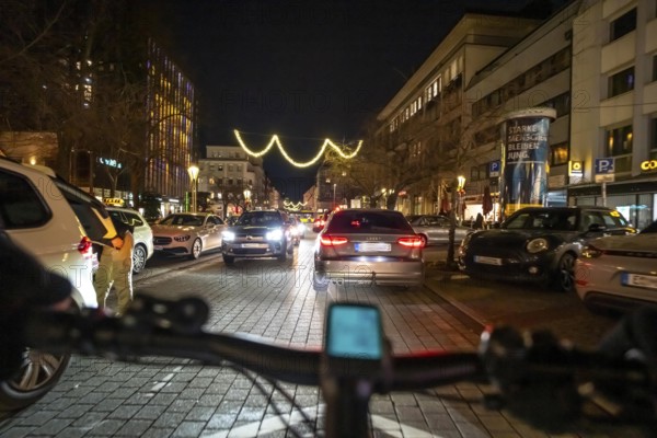 Cycling in the city, in the dark, in the evening, inner-city road, bicycle road, two-wheeler traffic has priority, 30 km/h zone, cyclist perspective, Essen, North Rhine-Westphalia, Germany