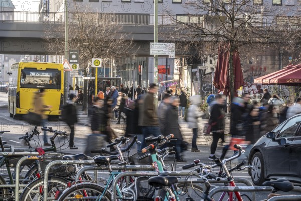 Passers-by on a GrunerstraÃŸe pedestrian crossing near Alexander Platz, bicycle parking lot in Berlin, Germany