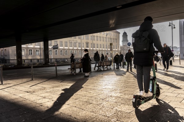 Passers-by on a sidewalk on GrunerstraÃŸe, near Alexander Platz, bus stop, in Berlin, shade, low sun, winter, Germany