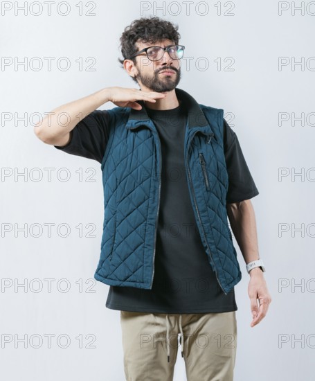 Man threatening with his finger to his throat, isolated. Person with a violent look threatening the camera