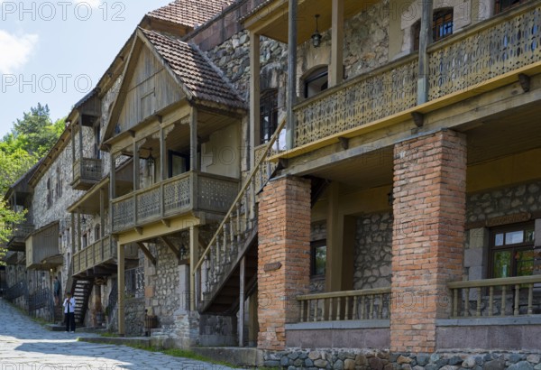 Row of old buildings with wooden verandas and brick walls on a cobblestone street in a quiet place, Old Town, Sharambeyan Street, Dilijan, Delijan, Tavush Province, Armenia