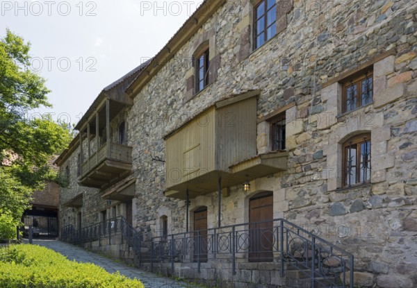 Stone building with many windows and historic charm, surrounded by nature, Old Town, Sharambeyan Street, Dilijan, Delijan, Delijan, Tavush Province, Armenia