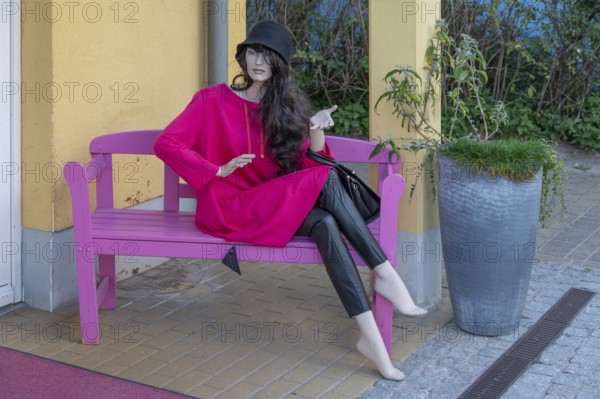 Seated mannequin fashionably dressed in front of a fashion shop, Ahrenshoop, DarÃŸ, Mecklenburg-Western Pomerania, Germany