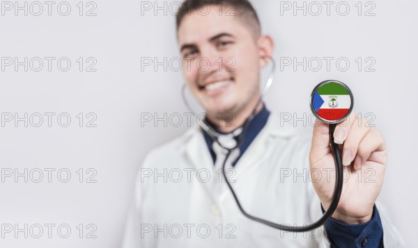 Doctor showing stethoscope with Equatorial Guinea flag. Equatorial Guinea national healthcare concept