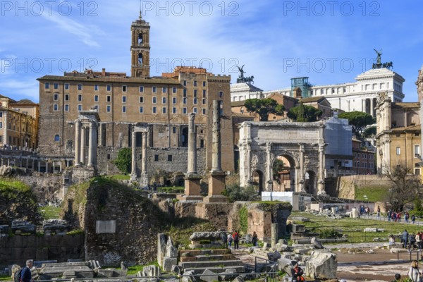 View of Roman Forum on left back ancient administrative building of Rome building from tabularium on capitol hill, right in the background Altare della Patria, in front right triumphal arch of Severus, in the foreground ruins remains pillars of ancient temples, Roman Forum, Rome, Lazio, Italy