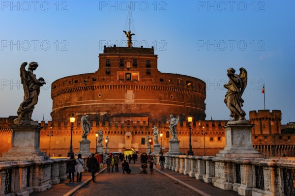 View of blue hour at nightfall in 139 AD as an ancient mausoleum Hadrian Tomb for Emperor Caesar Emperor Hadrian built Castel Sant'Angelo Sant'Angelo on the banks of the Tiber, in front of Ponte degli Angeli Angel Bridge with statues of winged beings angels, Rome, Lazio, Italy