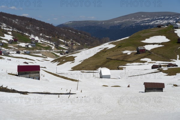 Snowy hills with scattered buildings and valleys in a mountainous landscape, view from Goderdzi Pass, Ajara region, Adjara, Autonomous Republic, Georgia
