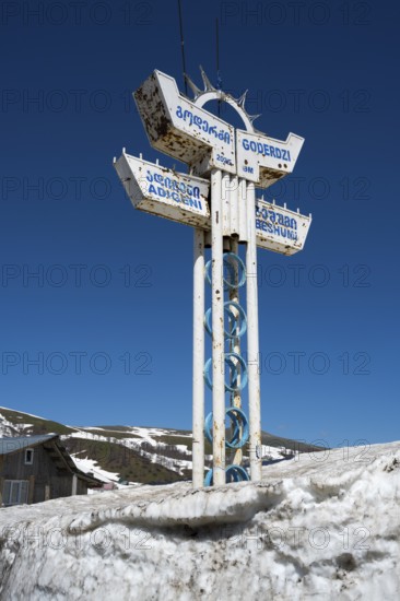 A sign in the snow at a mountain station under clear blue sky, Goderdzi Pass, Adjara region, Adjara, autonomous republic, Georgia