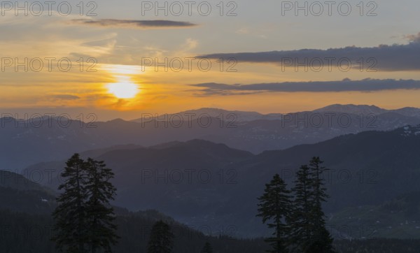 An impressive sunset over a mountainous landscape with a golden sky, view from Goderdzi Pass, Adjara region, Adjara, autonomous republic, Georgia