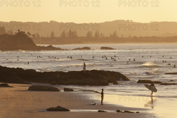 Fisherman Lookout, The Pass and surfers in the evening light of Byron Bay, New South Wales, Australia