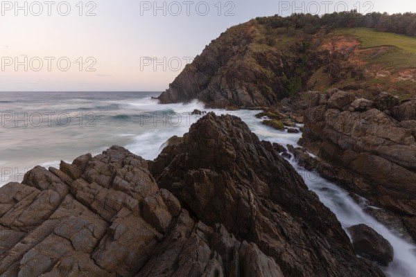 Rocks at the easternmost point of mainland Australia at sunset. Cape Byron near Byron Bay, New South Wales, Australia