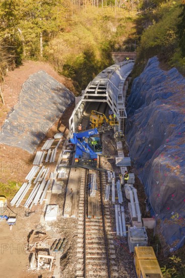 Aerial view of a construction site with railroad tracks and tunnel under construction, Hermann Hesse Railway bat tunnel construction site, Calw, Black Forest, Germany