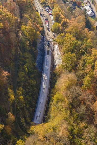 Tunnel project view from the air, surrounded by diverse autumn forest and infrastructure, Hermann Hesse Railway bat tunnel construction site, Calw, Black Forest, Germany