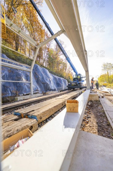 View along a rail line with metal structures under construction and a crane, Hermann Hesse Railway Bat Tunnel construction site, Calw, Black Forest, Germany