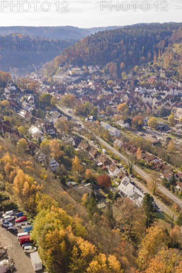 Aerial view of a town in an autumn landscape surrounded by hills, Hermann Hesse Railway Bat Tunnel construction site, Calw, Black Forest, Germany