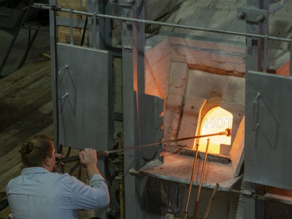 Glassblowers at work in front of kiln, Bohemia, Czech Republic