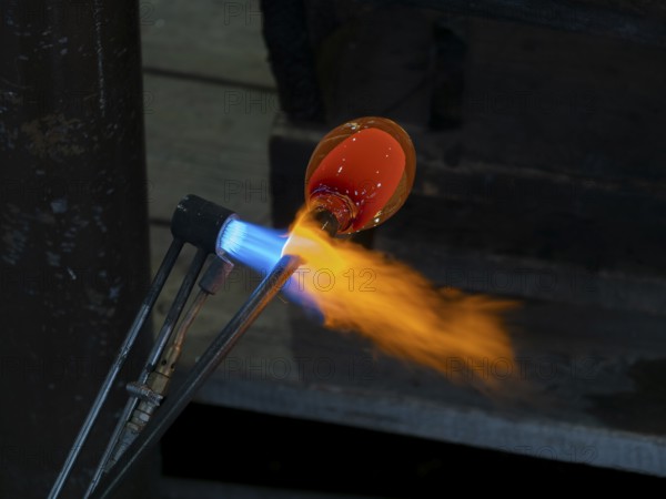 Glassblowers at work, molten glass and flames, Bohemia, Czech Republic