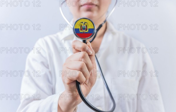 Female doctor holding stethoscope with Ecuador flag. National health system of Ecuador