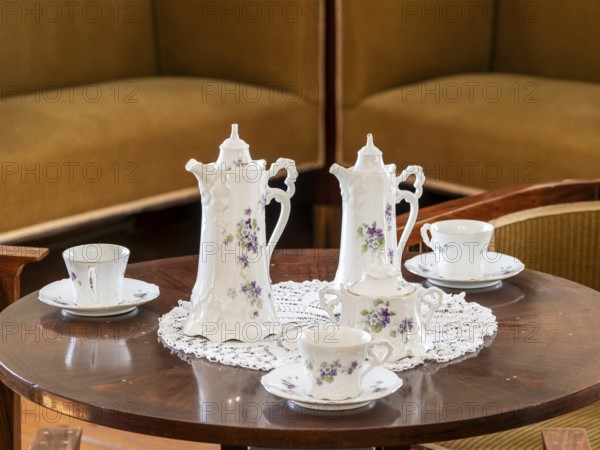 Vintage coffee service on the table, old porcelain