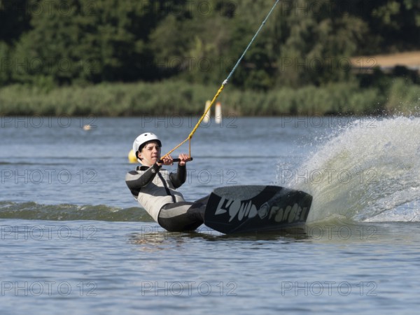 Young man with wakeboard, sporty on water, athletic model, active water sports, wake park