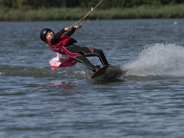 Boy or girl with wakeboard, sporty on the water, active water sports, wake park
