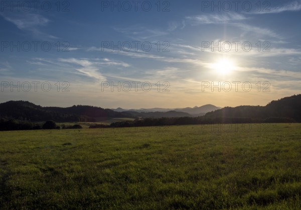 Sun over gentle mountain landscape and meadows, Bohemia, Lusetian Mountains, Czech Republic