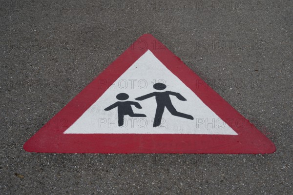 Traffic sign, children playing, road with marking on the asphalt, Bavaria, Germany