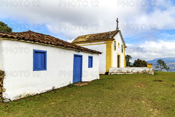 Small, old colonial-style chapel with an attached house in Minas Gerais, Minas Gerais, Brazil