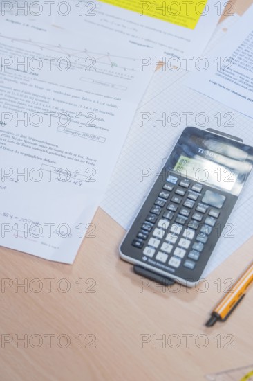 A calculator is lying on a table with mathematical documents, Jugend Forschungszentrum Nagold, Calw district, Germany