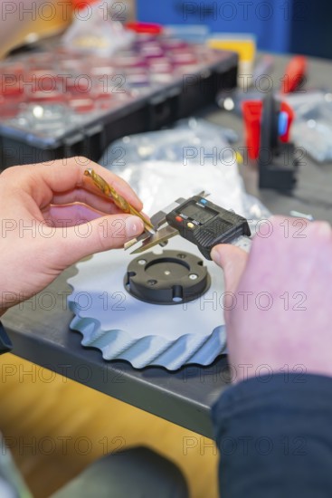 Person measuring component with caliper and drill, Jugend Forschungszentrum Nagold, Calw district, Germany