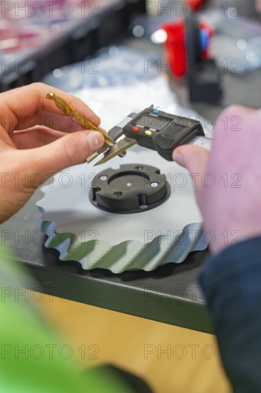 Caliper measures a black gear on a table, Jugend Forschungszentrum Nagold, Calw district, Germany