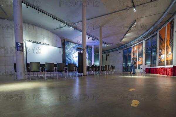 A modern gallery space with chairs and atmospheric lighting, Amazonia exhibition, Gasometer, Pforzheim, Germany