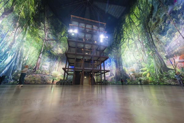 A multi-storey structure in a light-flooded artificial forest background, Amazonia exhibition, Gasometer, Pforzheim, Germany