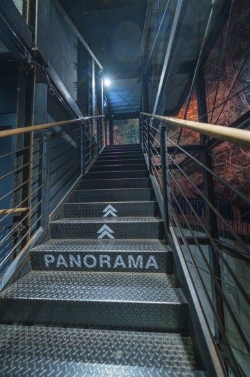 Metal staircase with the inscription 'PANORAMA' leading up to a blue light zone, Amazonia exhibition, Gasometer, Pforzheim, Germany