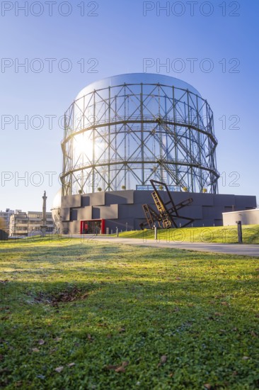 Round steel structure with green lawn underneath under blue sky, Amazonia exhibition, Gasometer, Pforzheim, Germany