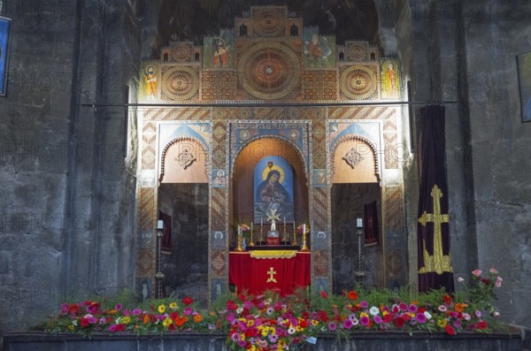 A richly decorated altar in a church surrounded by flowers and icons, Sevanavank Monastery, Gegharkunik Province, Armenia