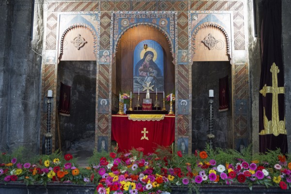 Magnificent altar in a church decorated with colorful flowers and religious paintings, Sevanavank Monastery, Gegharkunik Province, Armenia