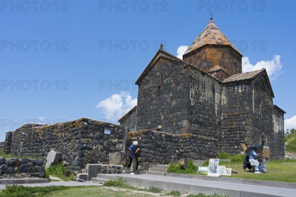 Visitors in front of a historic stone monastery under clear skies, Sevanavank Monastery, Sevan Monastery, Gegharkunik Province, Armenia