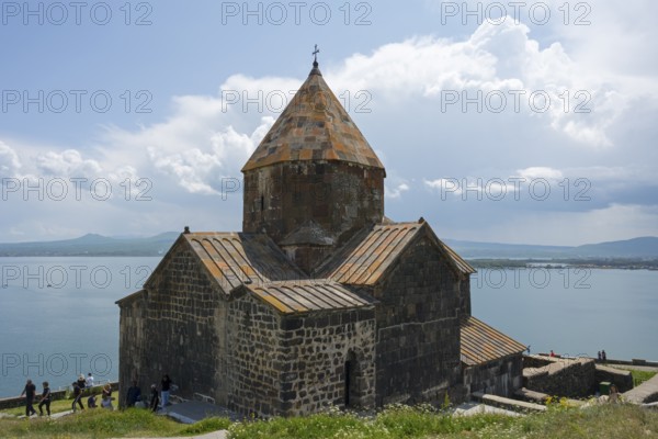 A historic monastery rises above a lake, with mountains in the background, Sevanavank monastery, Sevan monastery, Lake Sevan, Gegharkunik province, Armenia