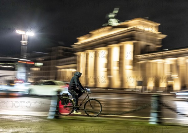 Cyclists, evening traffic on EbertstraÃŸe, on March 18, at Brandenburg Gate, Berlin, Germany