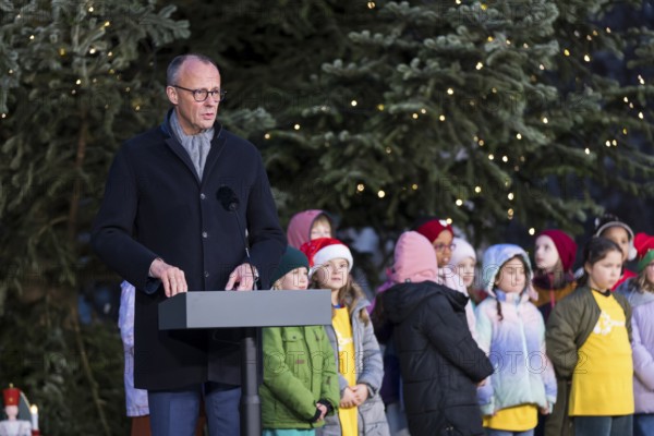 Friedrich Merz (CDU, Federal Chancellor of the Federal Republic of Germany) speaks in front of the Vocal Hero Children's Choir from Schöneberg elementary schools at the handing over of the Christmas tree to the Federal Chancellery, Berlin, 28.11.2025