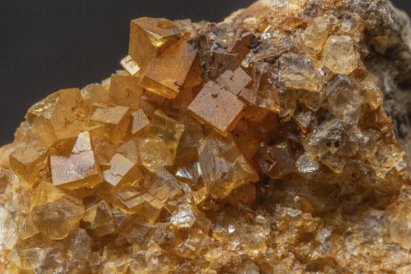 Brilliant crystals in blue and orange colors are visible in this mineral formation. They are sparkling and show interesting textures in natural surroundings. Bas Rhin, Alsace, France