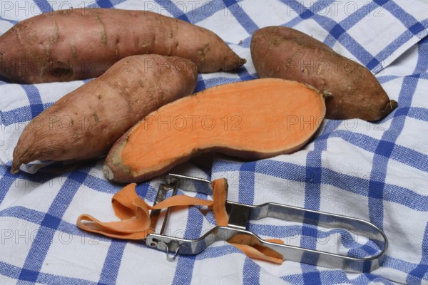 Sweet potatoes with potato peeler, Ipomoea batatas