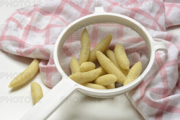 Raw Schupfnudeln in sieve, type of pasta, Germany