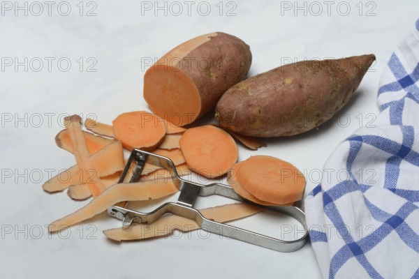 Sweet potatoes with potato peeler, potato slices, partially peeled, Ipomoea batatas