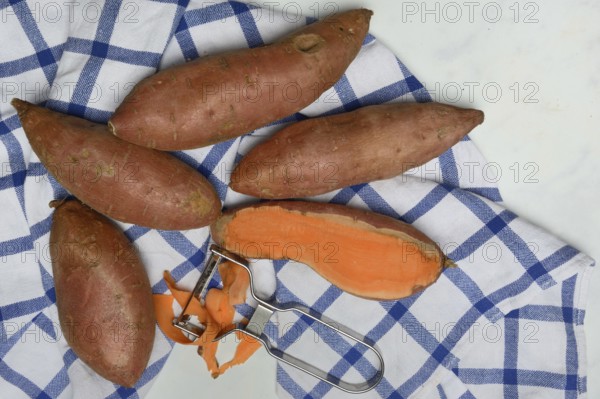 Sweet potatoes with potato peeler, Ipomoea batatas