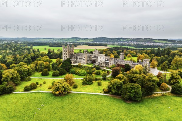 Autumn colours over Penrhyn Castle and Garden from a drone, Llandygai, Bangor, Gwynedd, North Wales, UK