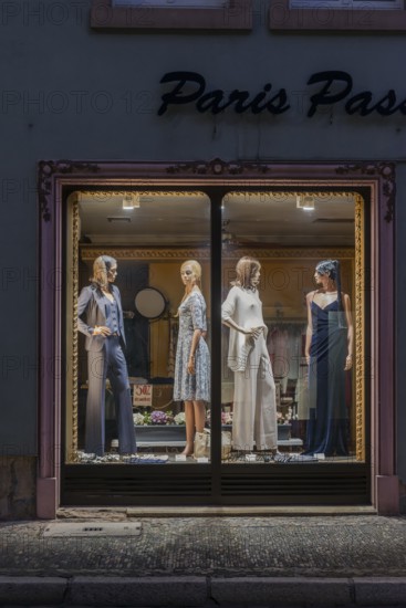 Fashion shop in evening mood with illuminated shop window