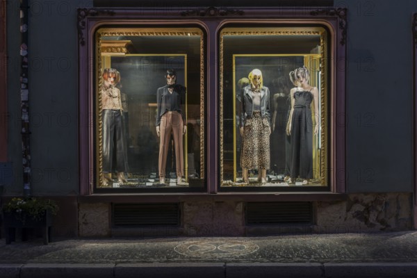 Fashion shop in evening mood with illuminated shop window