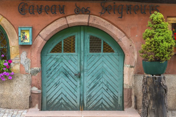 Antique wooden gate of a restaurant in Ellsass, France